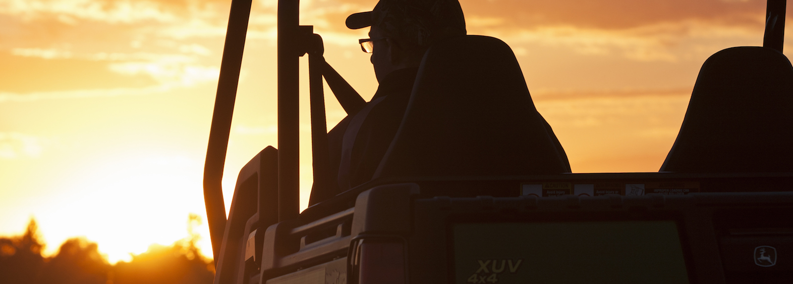 man on a vehicle at sunset