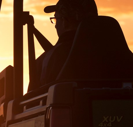 man on a vehicle at sunset
